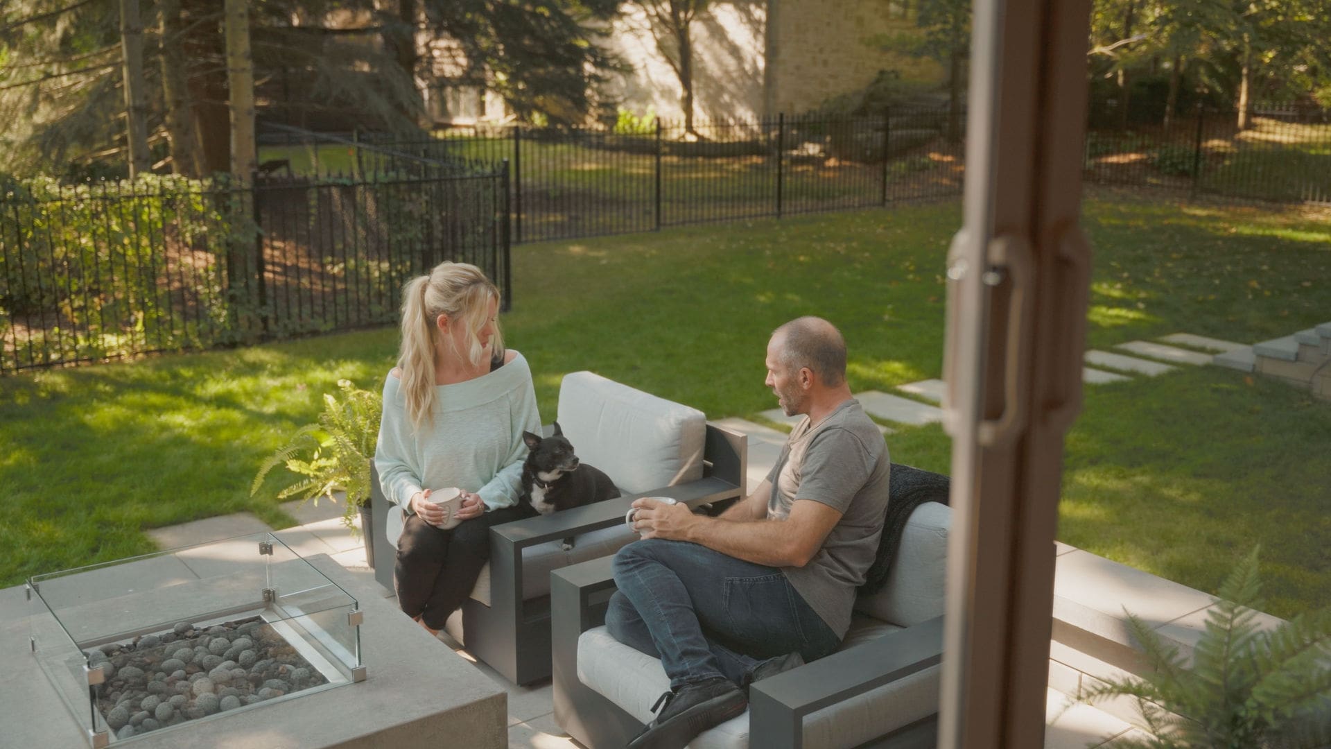 Mike Weaver and Carrie Rowan sitting outside on their back patio